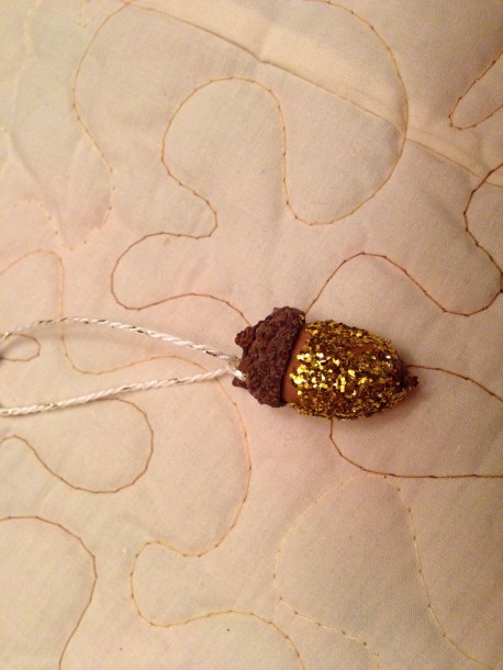 Glitter acorn ornament in gold. 